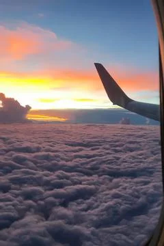 Twilight time before the sun sets through the airplane window. Stock Photos