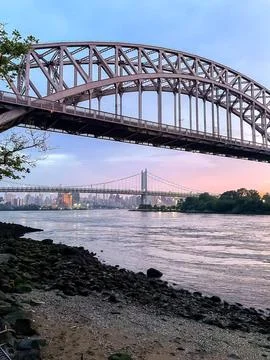 Twilight view of Hell Gate Bridge and RFK Bridge from East River Stock Photos