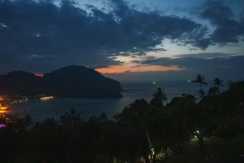 Twilight View of Koh Phi Phi with Palm Silhouettes and Coastal Lights Stock Photos