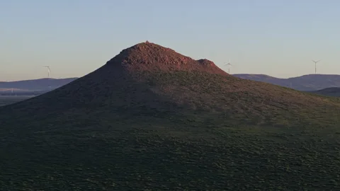 Twilight Volcanic Cone and Wind Turbines Forward Rise 4K HLG Stock Footage 343799567