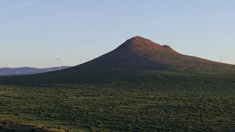 Twilight Volcanic Cone Wind Turbines Tracking 8K HLG Stock Footage 343799964