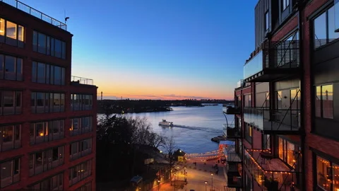 Twilight waterfront view between modern city buildings Stock Footage 336962671