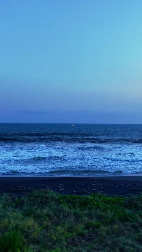 Twilight waves breaking on quiet dark beach Stock Footage 335432962