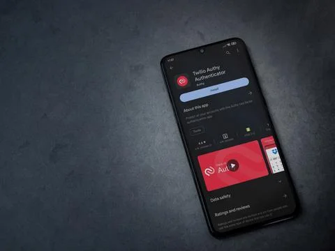 Twilio Authy Authenticator app play store page on smartphone on a dark marb.. Stock Photos