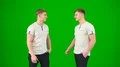 The twin brothers talk on the green background 4k or 4k+ Resolution