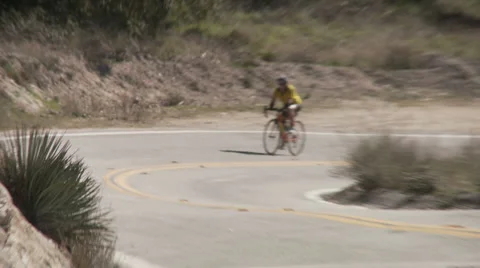 Twin cyclists in curve Stock Footage 1066277