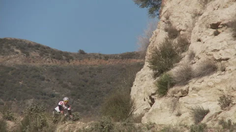 Twin cyclists downhill curve Stock Footage 1066244