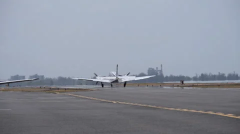 Twin engine airplane taxing down the runway Stock Footage 49509361
