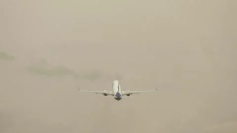 Twin engine jet airliner taking off into thick clouds with poor visibility and Stock Footage 309627100