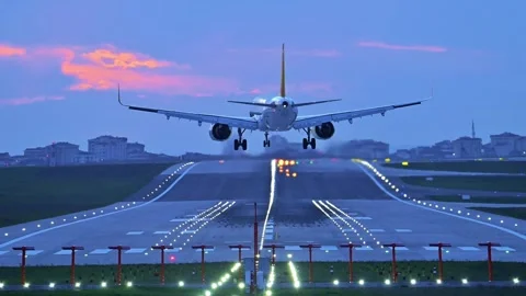 Twin-Engine Passenger Jet Landing in Strong Winds at Dusk Stock Footage 326175490