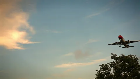 A twin-engine passenger plane flies overhead against the sky. Stock Footage 246736765