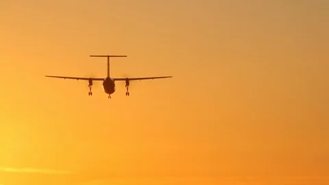 Twin engine propeller plane airplane aircraft landing at sunset HD Stock Footage 104019995