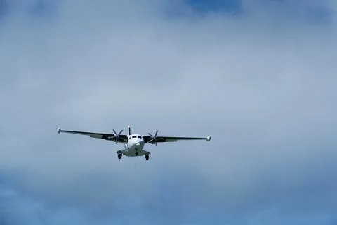 Twin-engine short-range transport aircraft on final approach to landing Stock Photos