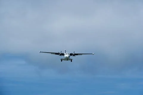 Twin-engine short-range transport aircraft on final approach to landing Stock Photos