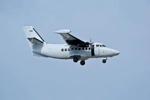 Twin-engine short-range transport aircraft on final approach to landing. Stock Photos