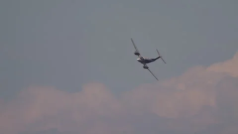 Twin engine turboprop aircraft in flight at sunset Stock Footage 324153199
