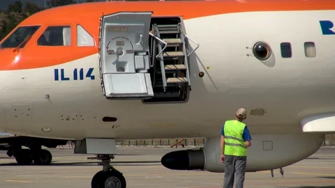 Twin-engine turboprop aircraft IL-114 with folding ladder for disembarking crew. Stock Footage 125610604