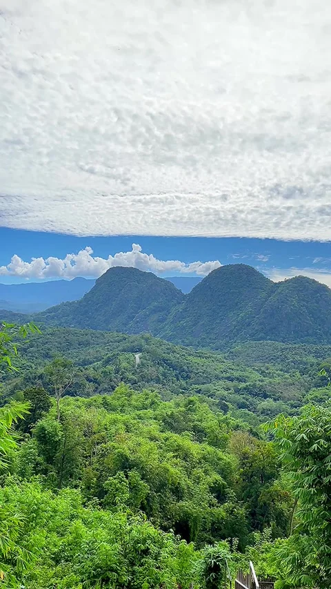 Twin Peaks of Meratus Mountains With Dramatic Cloudy Sky  and Tropical Forest Stockbeeldmateriaal 335066259