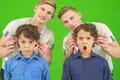 The twin play with a little brothers on the green background Photo