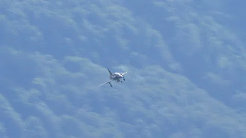 Twin seats green camouflage cold war fighter jet in flight with landing gear Stock Footage 146308881