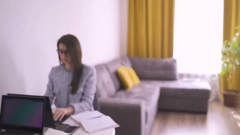 Twin sisters students elearning using laptops and taking notes with pen Stock Footage 130906389