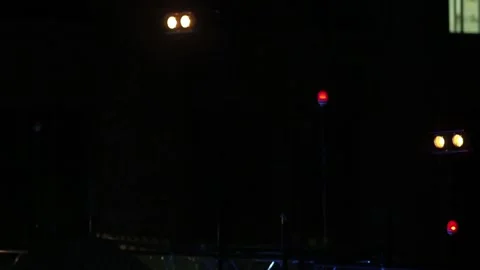 Twin spotlights and multiple red lights flash in the dark on stage in a loop Video stock 155211272