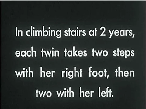 Twin two-year-olds learn how to climb stairs in the 1920s (title cards written 動画素材 75200042