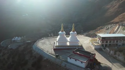 Twin white stupas on a Drak Yerpa monastery terrace aerial in Tibet Stock Footage 345881753