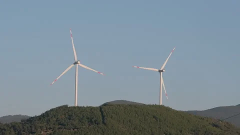 Twin Wind Turbines on a Hilltop Stock Footage 282926772