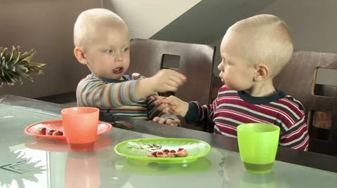 Twins feeding each other Stock Footage 11829653
