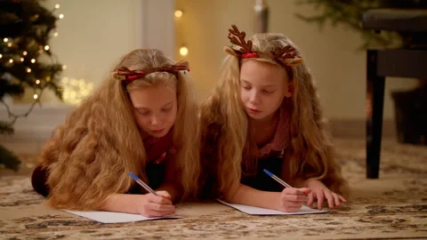 Twins Lying In Room And Write Letter To Santa Claus Near Christmas Tree Stock Footage 143039856