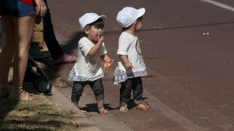 Twins pick up candy during Cinco de Mayo parade, 4K. Video stock 94239182