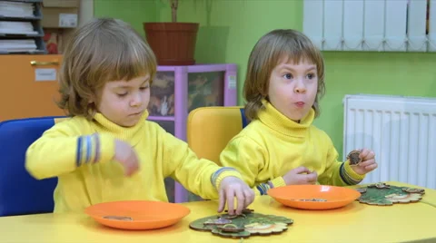 Twins play in a logical toy Stock Footage 64125053