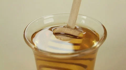 Twirler Dunked In Honey Stock Footage 1046244
