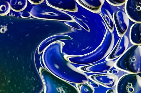 Twirling effect of bubbles on surface of water in blue gradient background Stock Photos