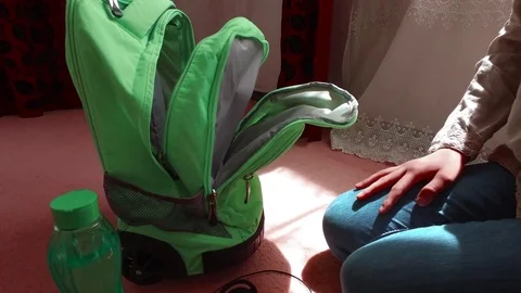 Twirls the charger, put in a backpack Stock Footage 79648207