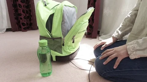 Twirls the charger, put in a backpack Stock Footage 79649658