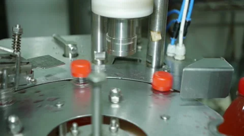 Twist caps for plastic bottles on an assembly line production of lemonade soda Stock Footage 65252417
