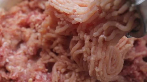 Twist farf in a meat grinder. Minced chicken comes out of the meat grinder Stock Footage 231773223