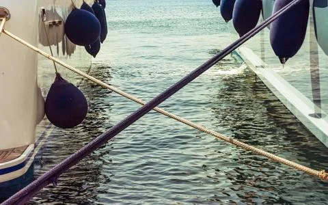 Twisted Anchoring Ropes Between Two Yachts. Isolated. Stock Photos