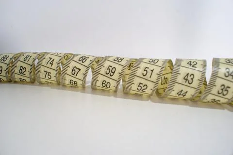 Twisted centimeters on a white background. Measuring tape isolate. Flexible m Stock Photos