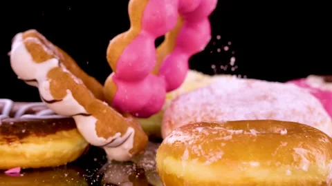 Twisted Chocolate Donut Dropping Onto Assorted Pastries Stock Footage 314879005