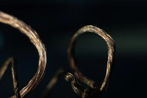 Twisted copper wire in the dark background Stock Photos