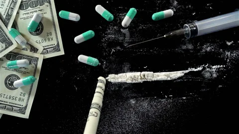A twisted dollar bill pulls in a line of cocaine in slow motion. Stock Footage 132345889