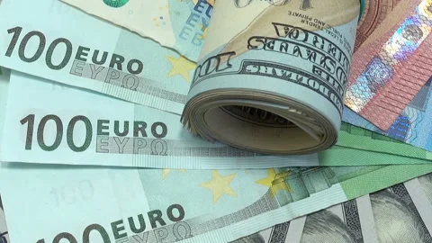 Twisted dollar bills on dollar and euro bills. Stock Footage 236925345