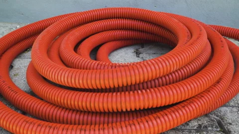Twisted Empty orange cable protection pipe tube for fiber optic cable Stock Footage 133610061