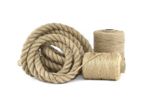 Twisted jute rope and spools of burlap threads or jute twine isolated on white 写真素材