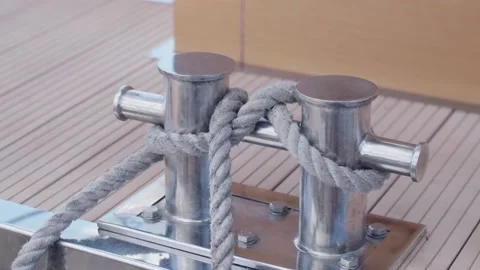Twisted knot keeps boat at the dock. mooring rope on a steel bollard. Stock Footage 201389202