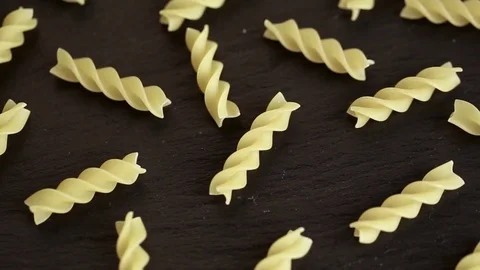 Twisted pasta on a black background Stock-Footage 83759612