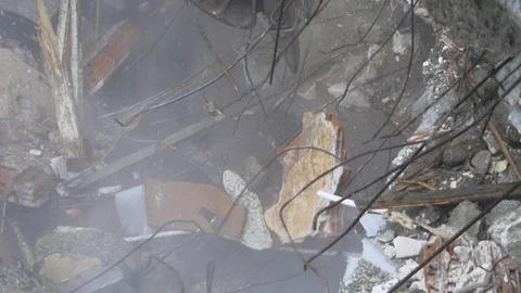 Twisted rebars, broken pillars and scattering concrete dust building demolition Stock Footage 88475991